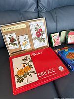 Open Piatnik Rosier bridge set showing floral decks, score pad, pencil and outer red box