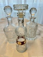 Front view of all three crystal decanters with stoppers