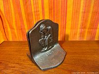 Front view of one bookend showing seated figure and "STUDY" text