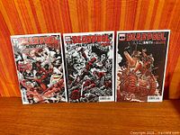 Three variant cover comics bagged and boarded, displayed upright