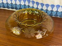 Oblique view showing amber glass bowl and etched floral design