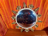 Front view of Deknudt brass sunburst mirror showing full frame and convex glass
