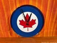 Front view of clock face showing RCAF roundel design and hand set