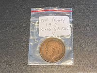 Coin in labeled plastic bag obverse visible