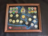 Full view of framed coin set showing all coins and map background