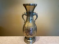 Full view of the bronze baluster vase showing shape, handles and decoration