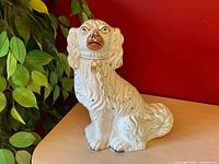 Full view of ceramic Staffordshire spaniel figurine on tabletop