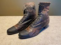 front and side view of both boots highlighting two-tone leather and lacing