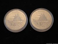 Front view of both Winnipeg design medallions showing building and legend