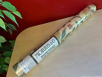 Full view of sealed Morris & Co. wallpaper roll