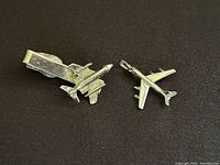 Pendant and tie clip side by side showing overall design and scale