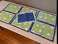 Set laid out showing green floral side with centre mat on top
