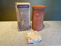 Wine cooler standing beside illustrated Paysanne box and tissue-wrapped cork base