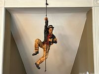 Front view of Charlie Chaplin hanging figure on rope