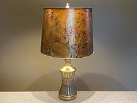 Full view of brass table lamp with amber mica shade