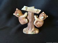 Front view of ceramic bear salt & pepper shakers on tree stand