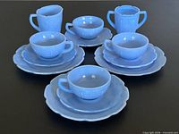 Full 13-piece Delphite blue Cherry Blossom tea set displayed