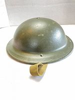 Exterior top view of olive drab steel Brodie Mk II helmet