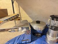 Bread box, fryer with lid, blender grouped together