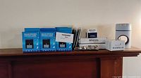 Lot overview showing all boxed and packaged items on mantel