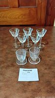 Group of seven etched glasses: five stemmed, two non-stemmed