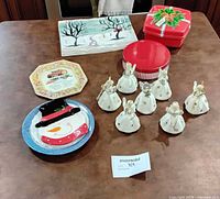 Group shot of plates, angel figurines, tins and plaque