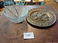 Crystal bowl with Boyes tongs and metal charger overall view