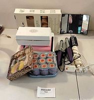 Overview of lot showing hair tools, hot rollers, gift set, shoe trees box, scale