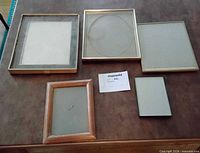 Front view of five assorted frames showing materials and glass fronts