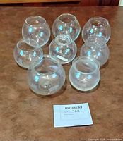 Eight clear glass globes arranged on tabletop