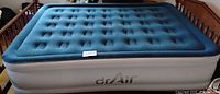 Top view of blue-topped white Dr Air double-height air mattress