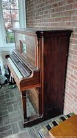 Side view of Emerson upright player piano showing case condition