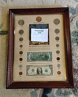 Full view of framed Presidential Collection display showing coins and currency layout