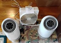 Front view showing two Aerclear air purifiers and Holmes box fan