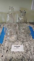 Group shot showing all clear glass bottles, vases and jars