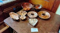 All items on tabletop showing bowls, molds, pans