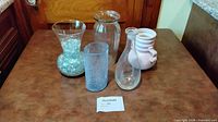 Group shot of five vases on table