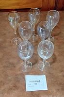all six clear glass white wine glasses arranged together