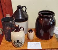 Group shot of all jugs, crock and metal container