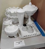 Group shot of milk glass items on table
