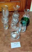 Group shot of all nine clear and green glass pieces