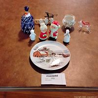 Group shot showing all items: plate, art glass pieces, Santa & Mrs. Claus, angels, reindeer, bowl, skier