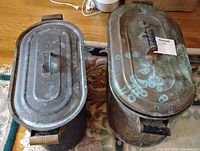 Top view of both copper scuttles with lids showing patina and verdigris