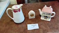 Group shot showing pitcher, house teapot and mantel clock