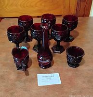 Group view showing seven goblets, creamer, sugar bowl, bud vase