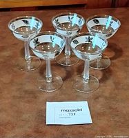 All five champagne coupes arranged together
