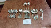 Entire flatware set grouped by type on table
