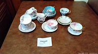 Group shot of all teacups, saucers and creamer on table