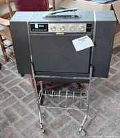 Front view of closed RCA Victor record player on chrome stand