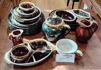 Entire lot showing dinner plates stack, serveware pieces, teapot, pitchers, dishes and mug